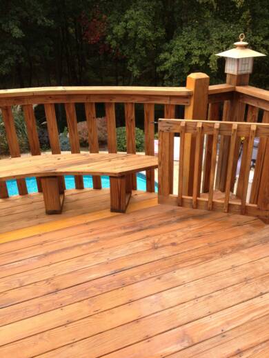 Beautifully restored floor, railing and bench on this deck