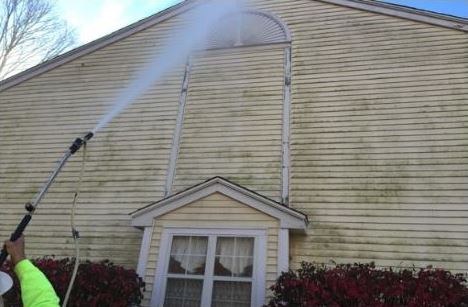 Power washing to the rescue on the dirt and harmful growths on the outside of this building